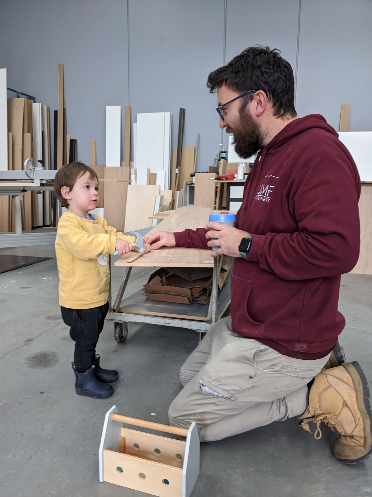 Josh Foley in the JMF workshop with his young son