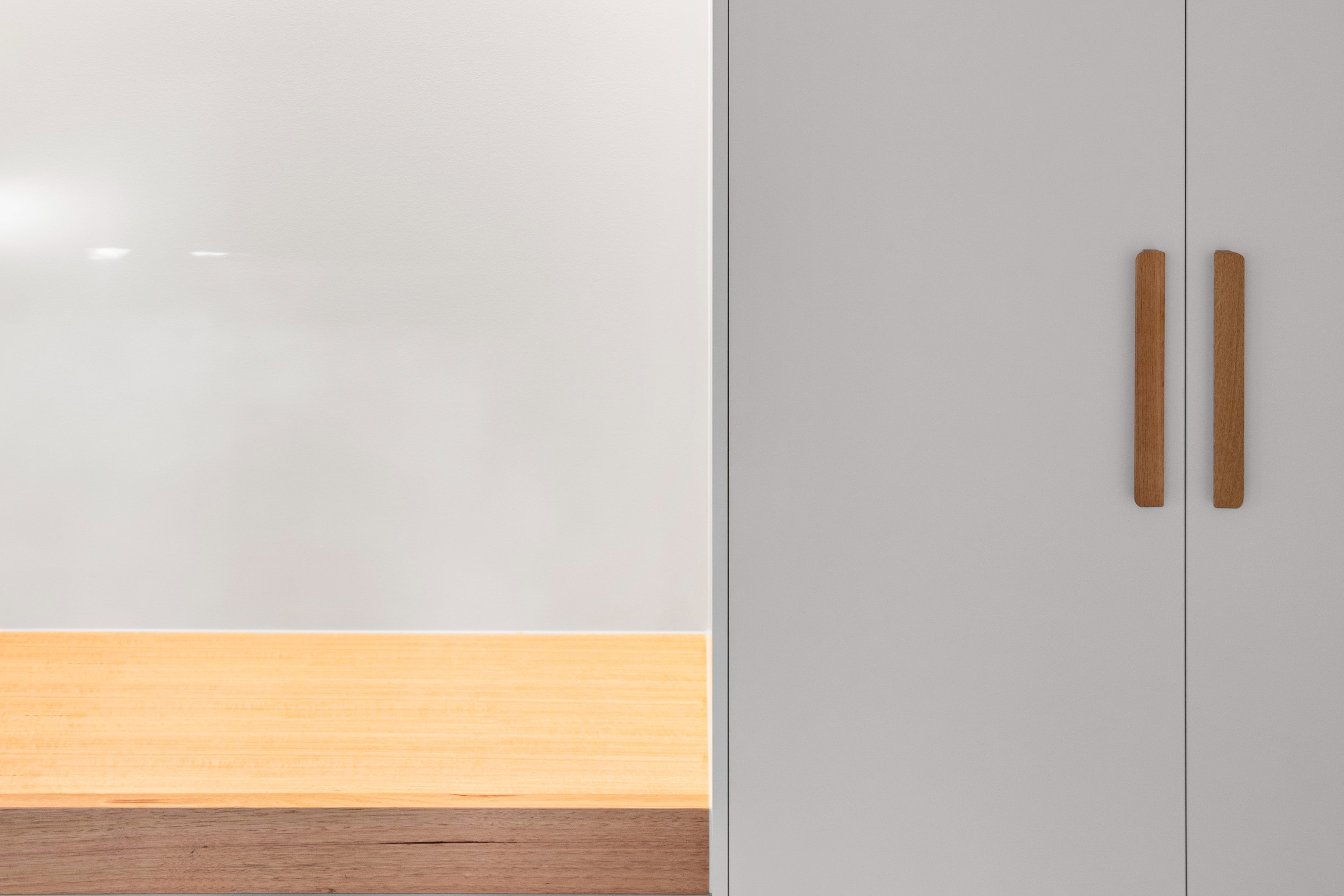 Built-in wardrobe with timber bench and coat hooks